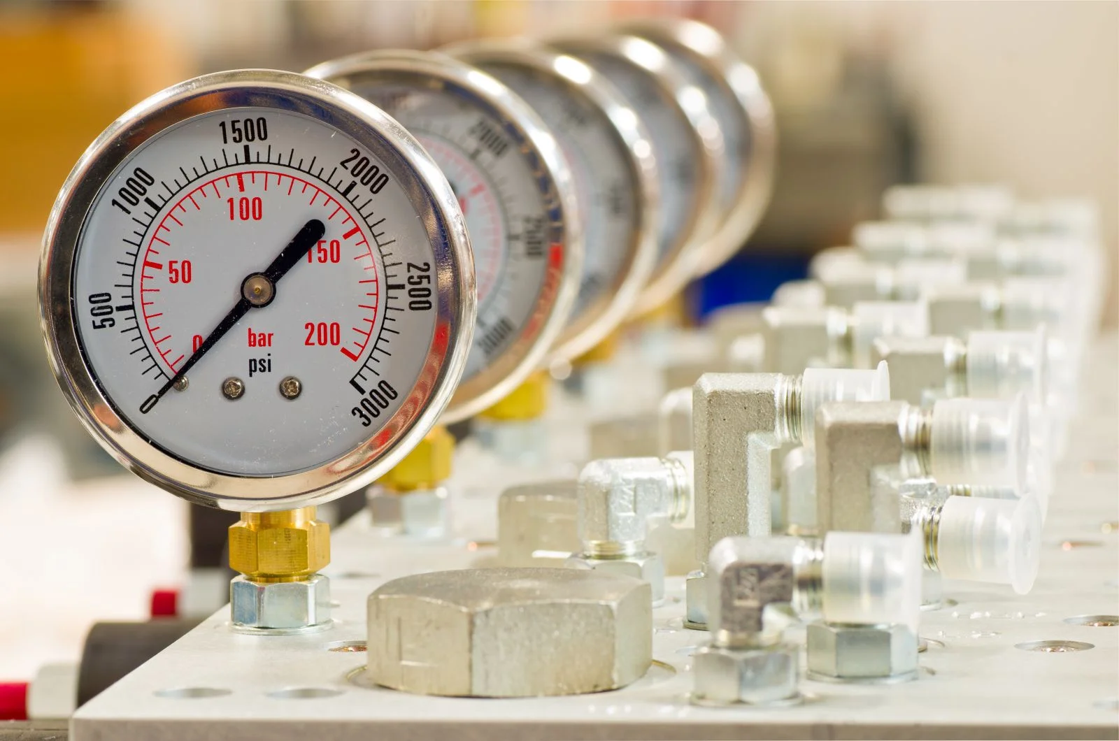 Pressure gauges and fittings on a calibration bench