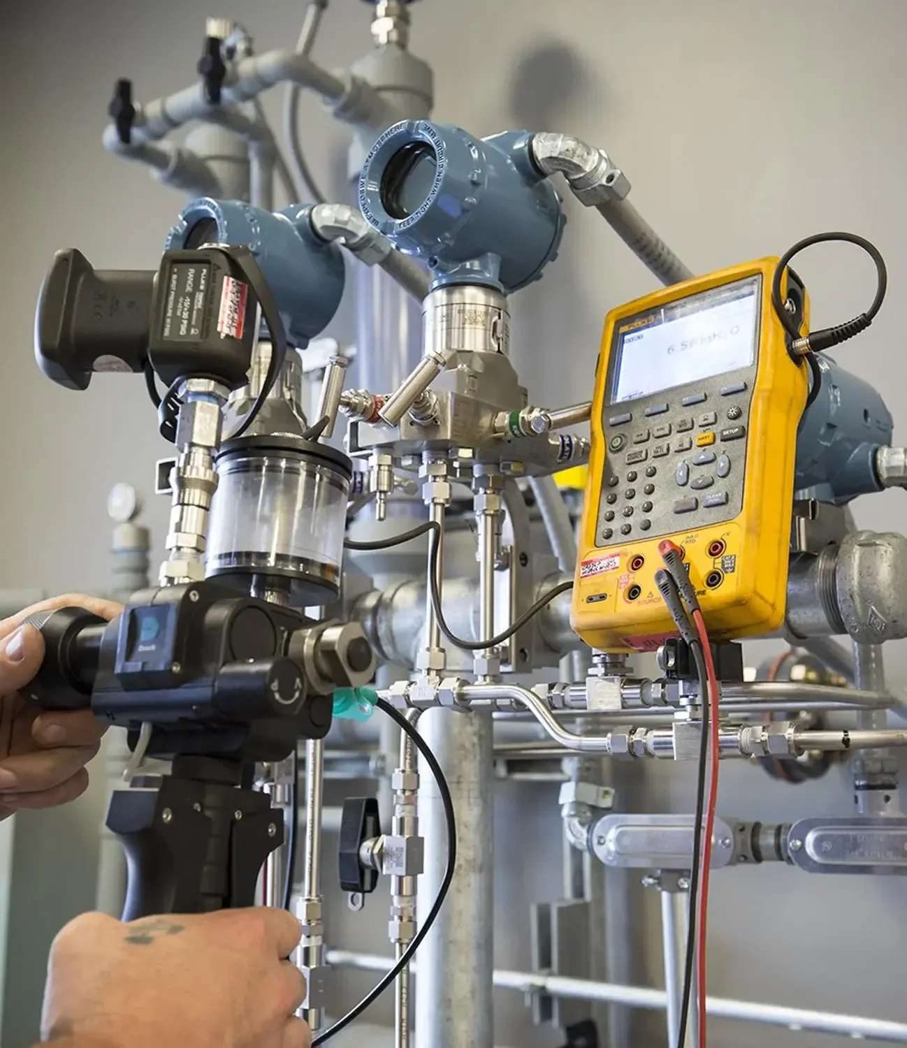 An engineer calibrating process instrumentation on site
