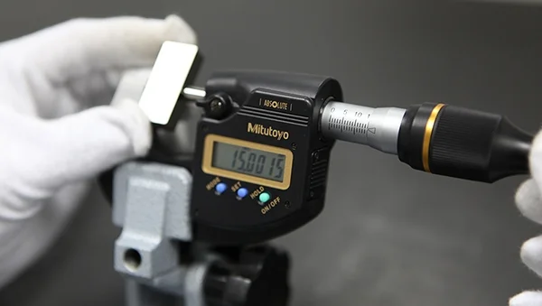 A digital micrometer being read during a dimensional calibration